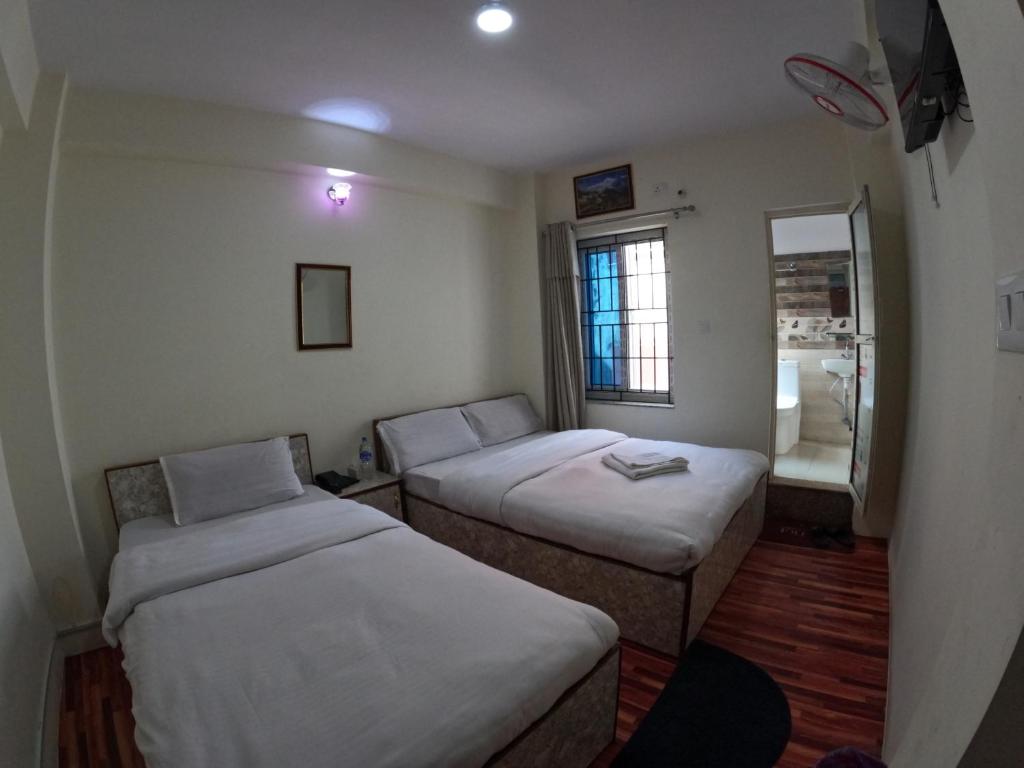 Postel nebo postele na pokoji v ubytování Hotel Global Village
