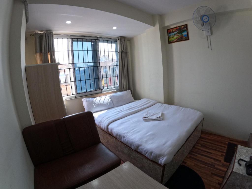 Postel nebo postele na pokoji v ubytování Hotel Global Village