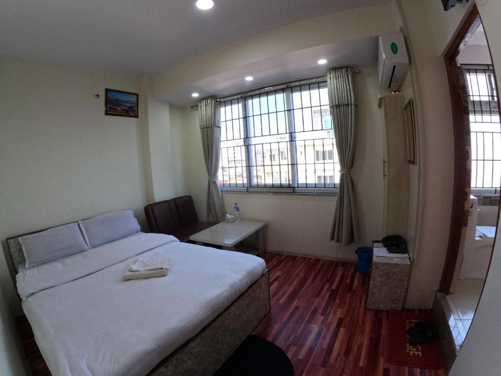 Postel nebo postele na pokoji v ubytování Hotel Global Village