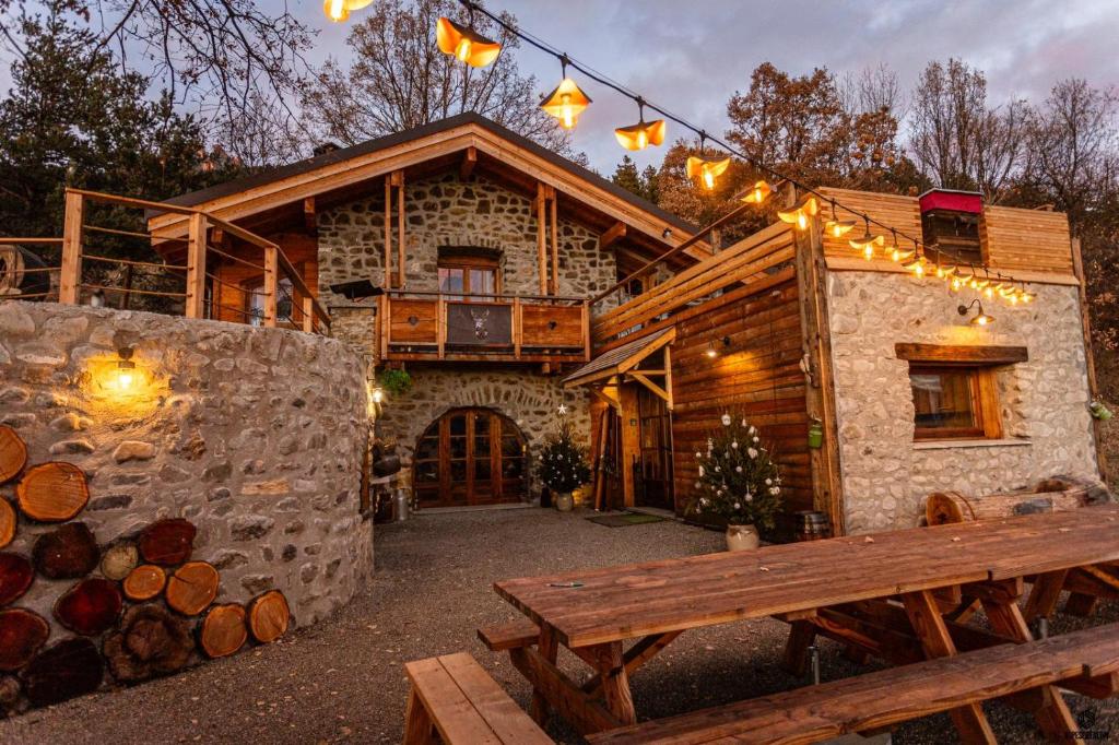 a log cabin with a bench in front of it at LE REFUGE DES TOUPINS in Prunières