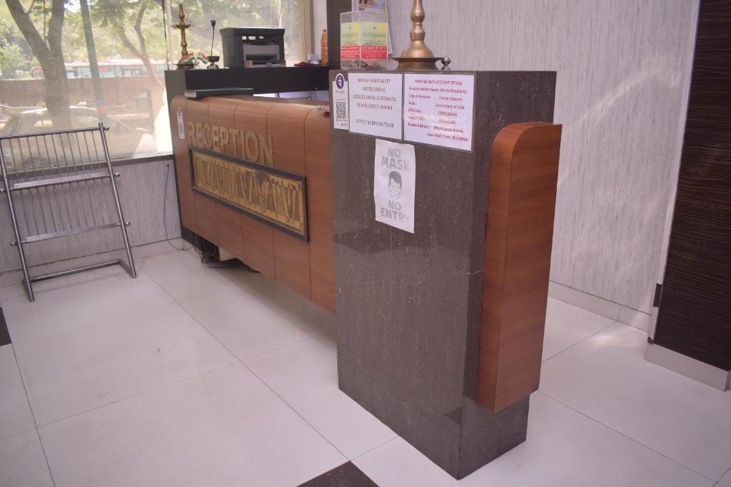 a counter in a restaurant with signs on it at HOTEL DHIRAJ in Thane