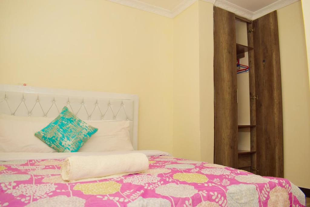 a bedroom with a bed with a colorful blanket at Fully furnished one bedroom in Thika Cbd in Thika