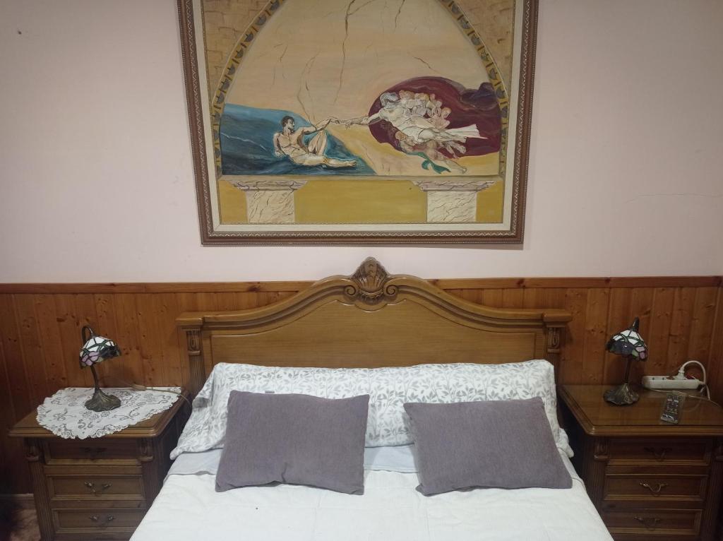 a bedroom with a bed with a painting on the wall at CA ÁNGEL in Anna