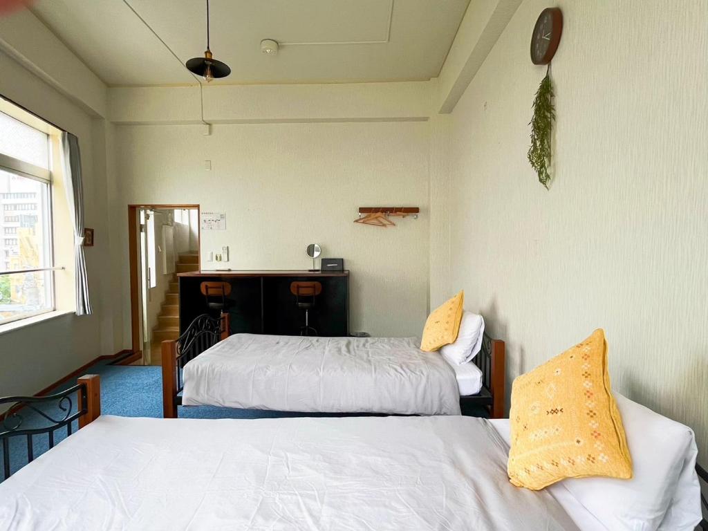 Postel nebo postele na pokoji v ubytování Guest House Umikaji
