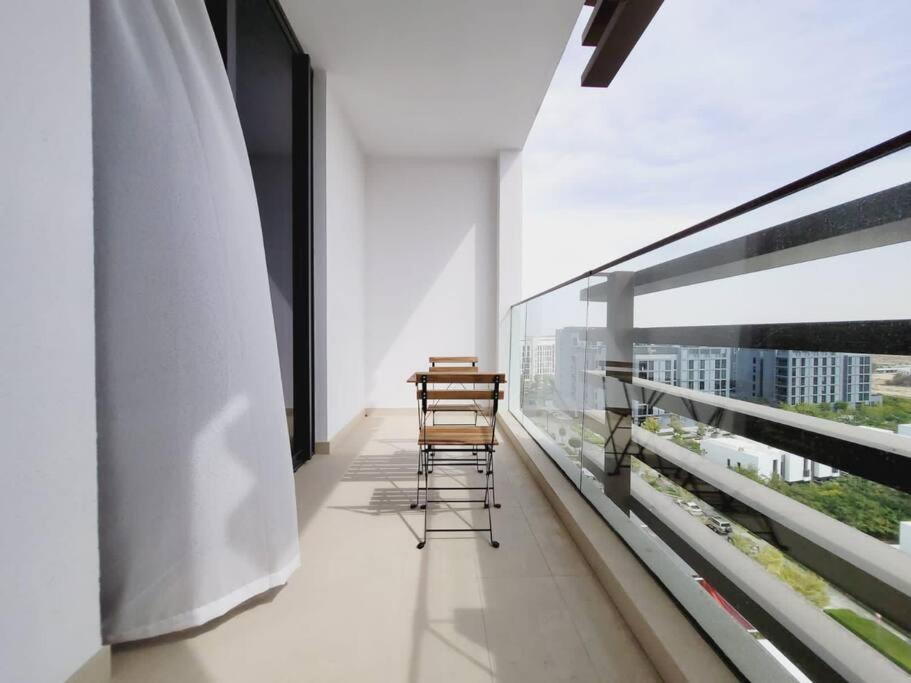 two chairs sitting on the balcony of a building at Luxury cozy apartment Al jda in Sharjah