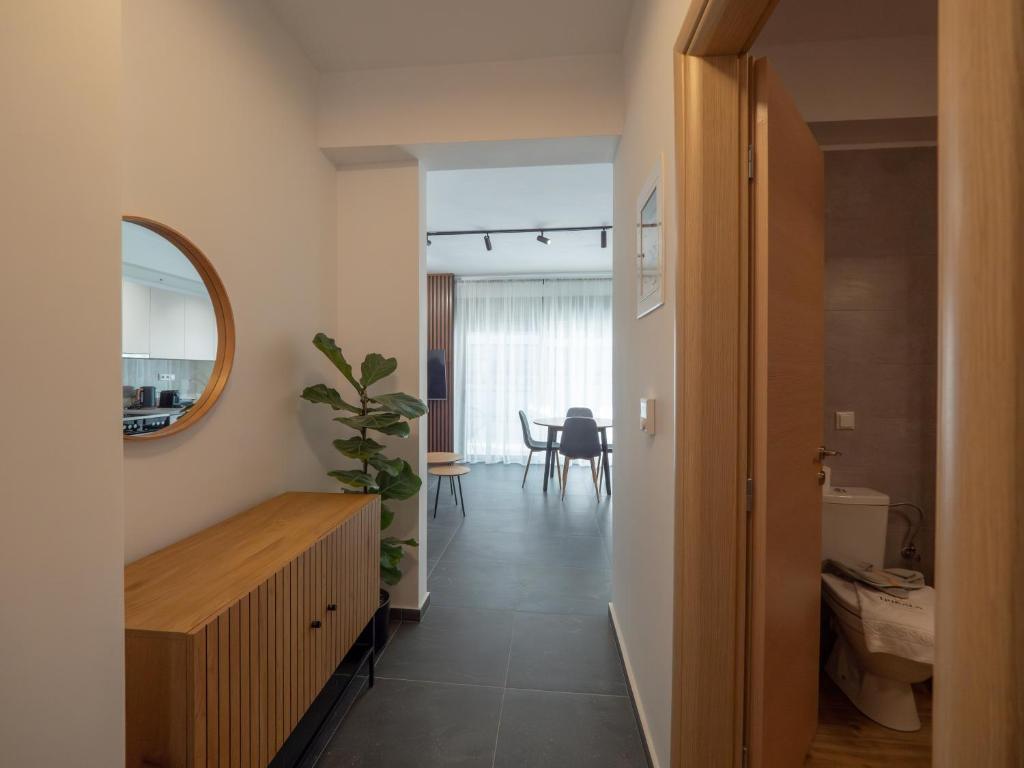 a room with a hallway with a mirror and a table at Trikala Leisure in Tríkala