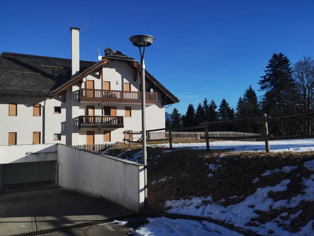 a building with a light pole in front of it at Lo Chalet del Golf Club in Tarvisio