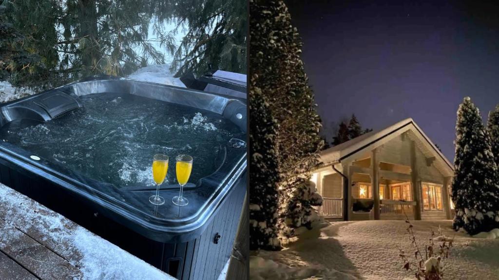 Due bicchieri di champagne in una vasca idromassaggio nella neve di Upea villa lähellä rantaa poreallas & SUP-laudat a Vaasa