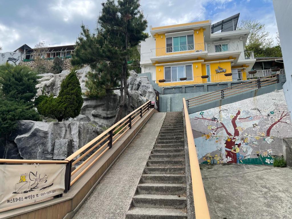 a staircase leading up to a house on a mountain at Moonlight Hill Guesthouse in Mokpo