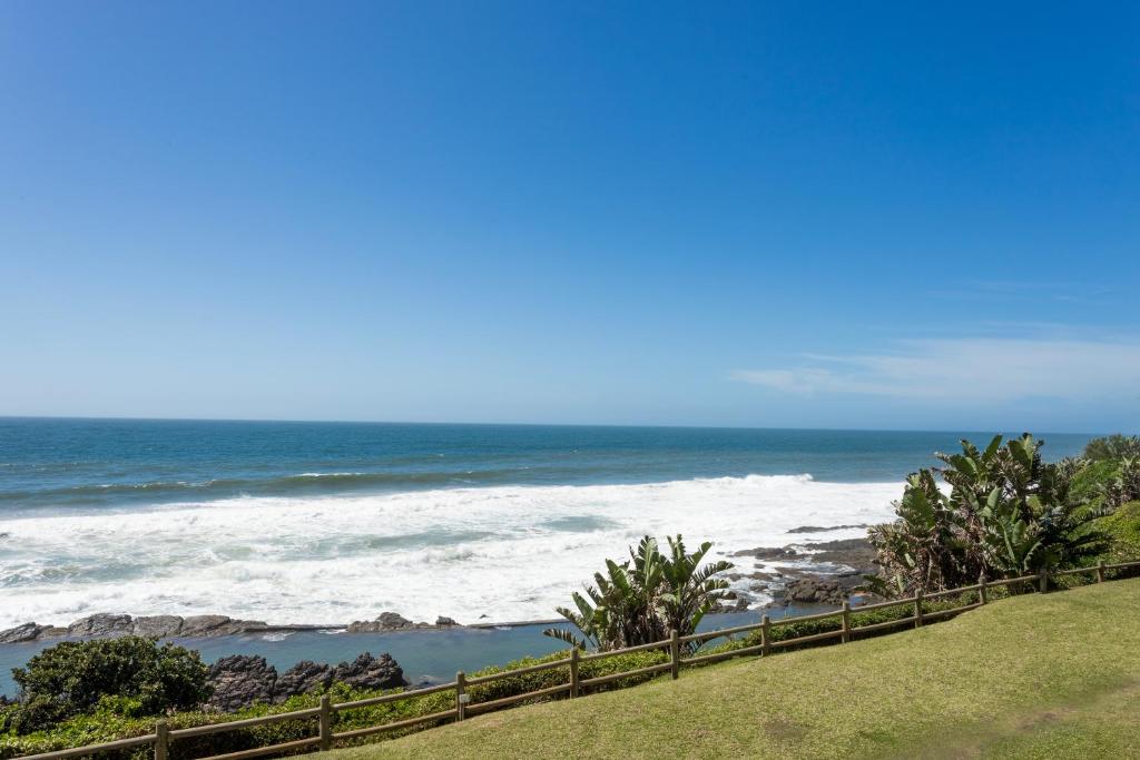 a view of the ocean from a bluff at Ocean Pearl at Chakas Cove - Beachfront Apartment in Ballito