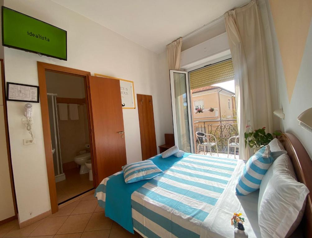 Łóżko lub łóżka w pokoju w obiekcie Hotel Villa Caterina