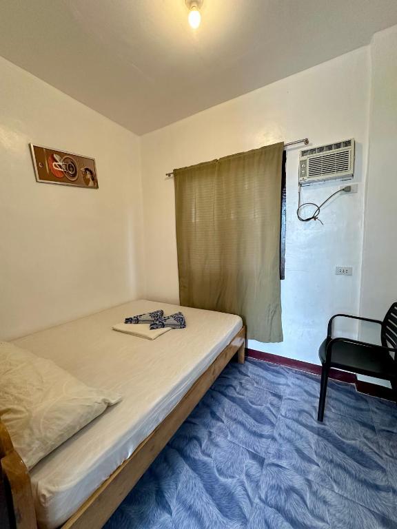 Postel nebo postele na pokoji v ubytování Marz inn Moalboal