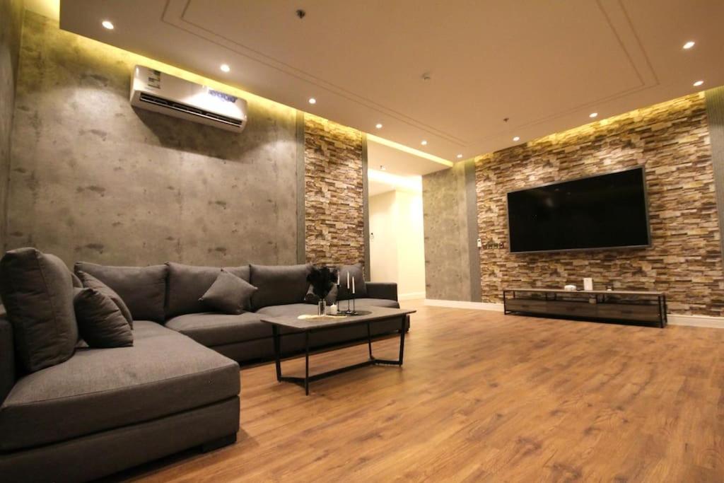 a living room with a couch and a flat screen tv at شقة ارضية واسعة Spacious Ground Floor Apartment in Riyadh