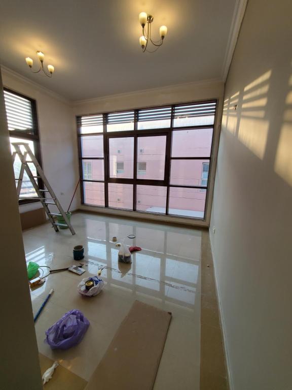 a room with two windows and a table with tools at Cozy private room near World Trade center and metro in Dubai