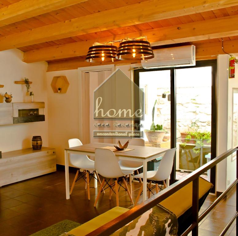 a dining room with a table and chairs at Casa vacanza home Ragusa in Ragusa