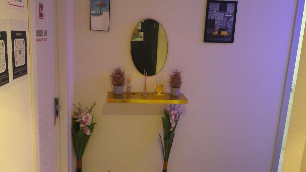 a room with a mirror and a shelf on a wall at Ruby Star Hostel Dubai F2 in Dubai
