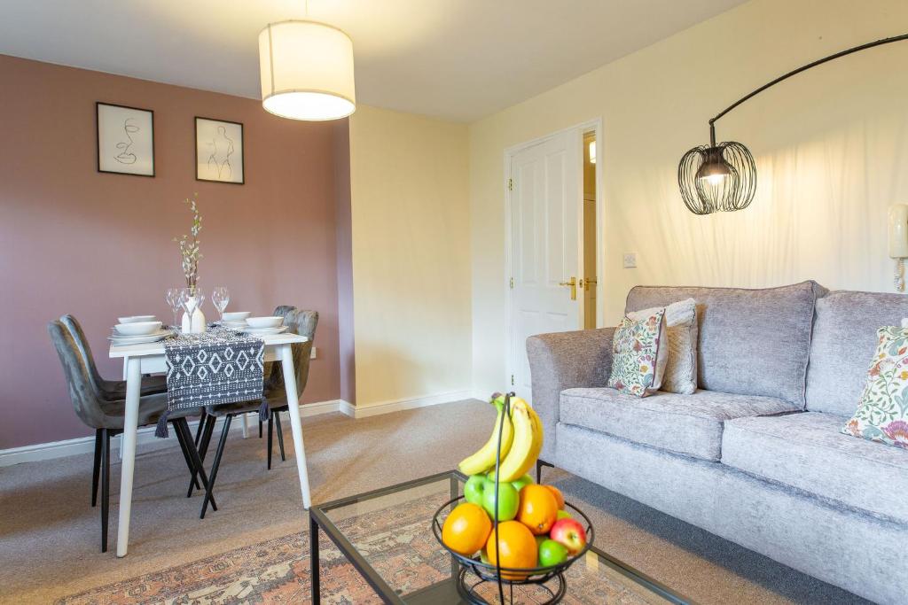 a living room with a couch and a table at Seager Apartments, Comfortable Cardiff Bay Apartment in Cardiff