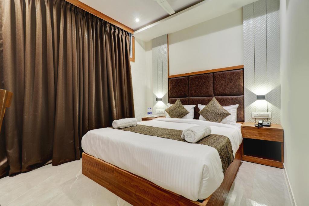 a bedroom with a large bed in a room at Hotel Sion Fort in Mumbai
