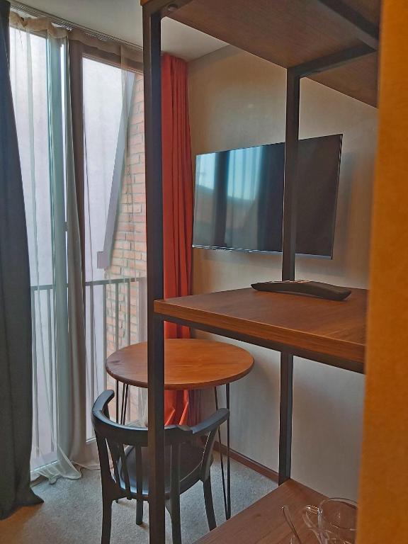 TV a/nebo společenská místnost v ubytování Green Inn Hotel