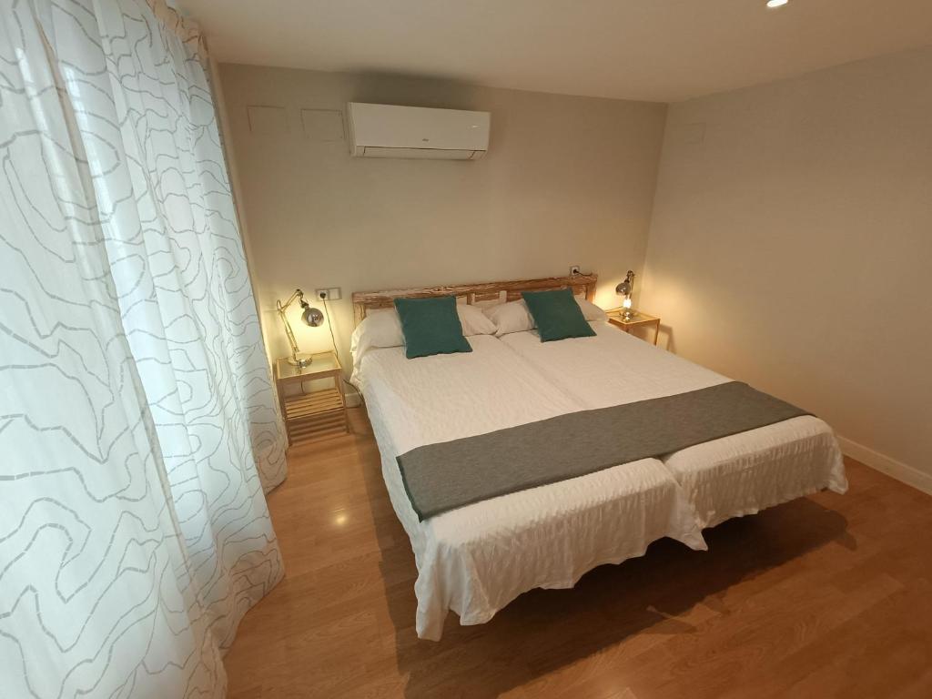 a bedroom with a large bed with green pillows at Centro ciudad in Seville