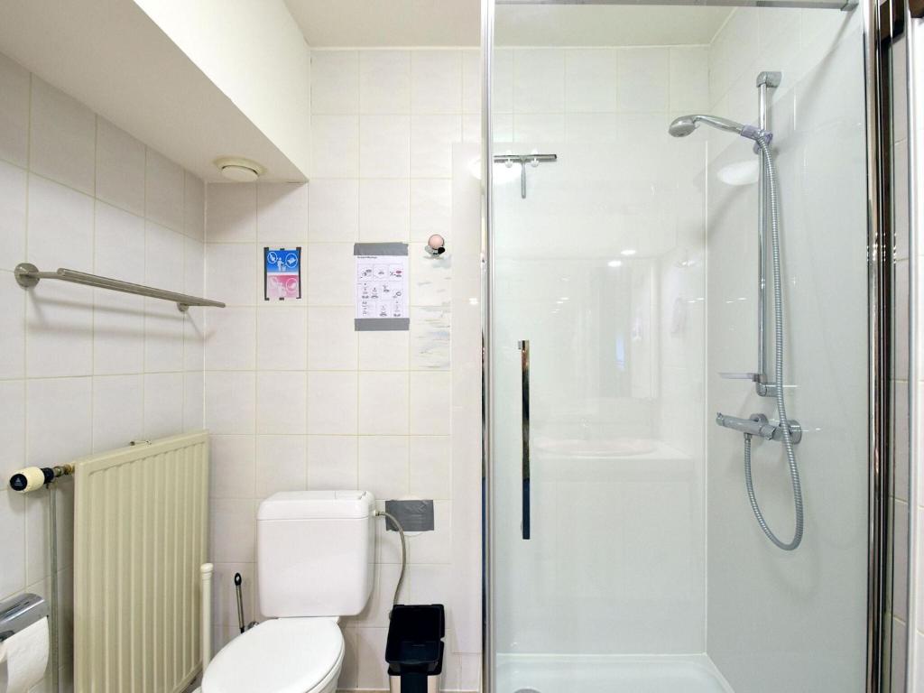a bathroom with a toilet and a shower at Blomme 0202 exclusive apartment with sea view in De Haan