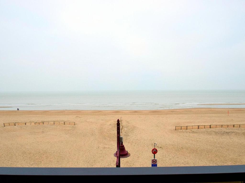 a view of a beach with the ocean in the background at Blomme 0202 exclusive apartment with sea view in De Haan