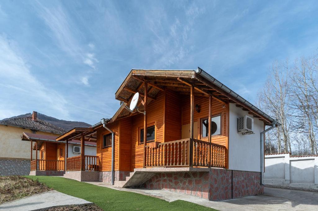 a log home with a porch and a deck at Елата in Zasele