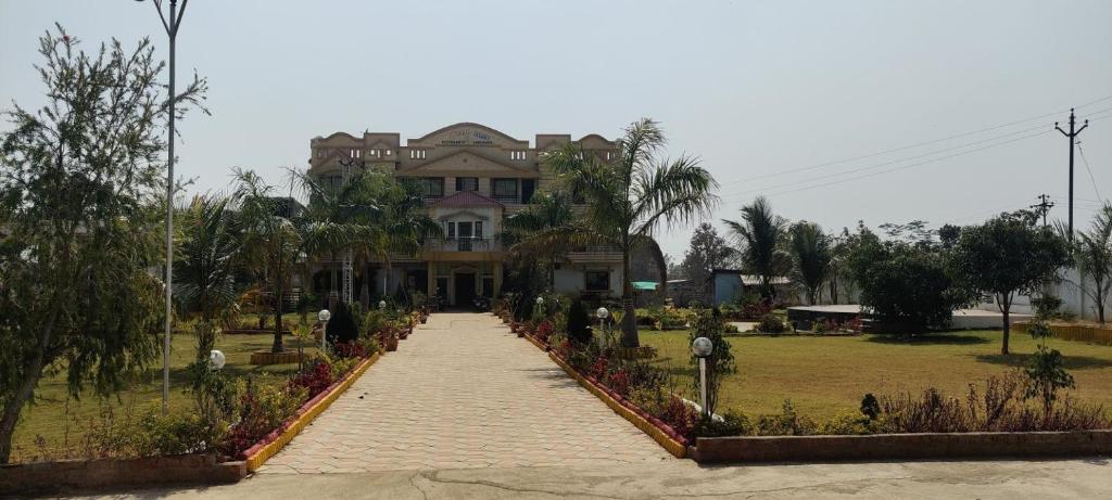 a large house with a walkway in front of it at Gaurav Resort in Rāmtek
