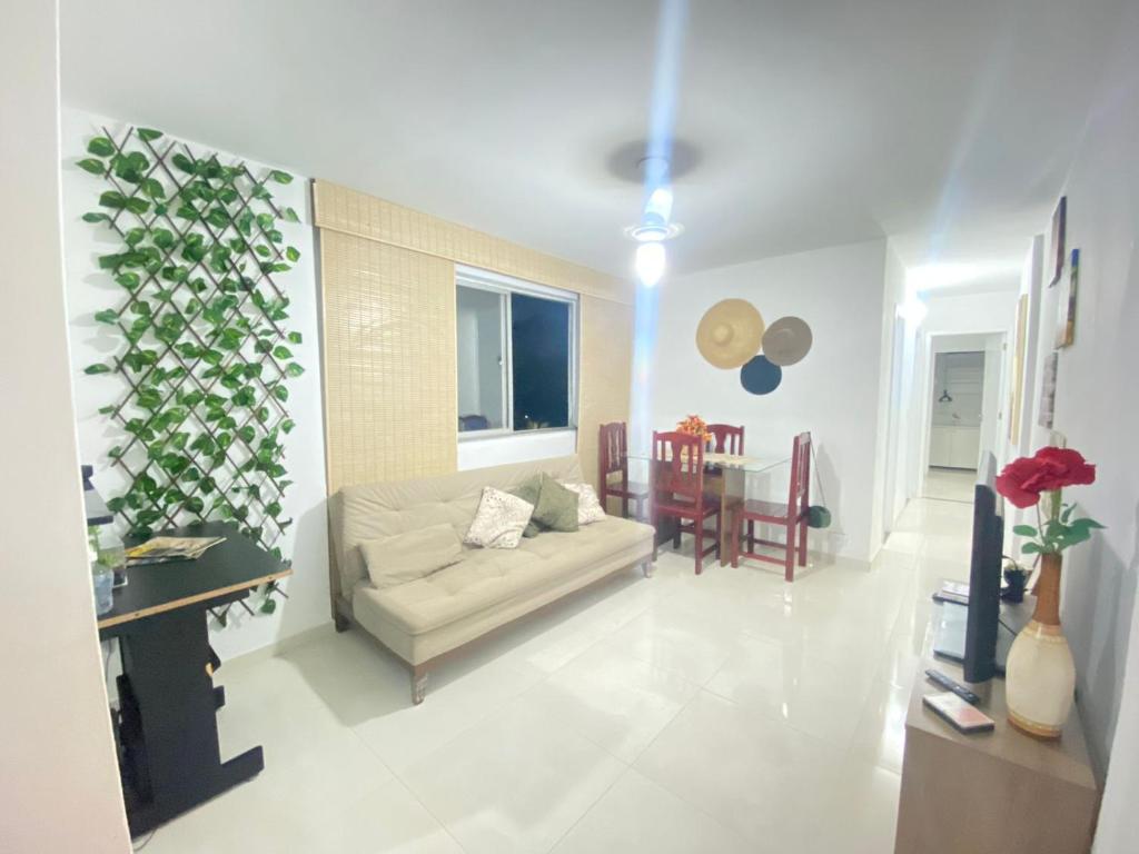 a living room with a couch and a table at Apartamento 2 quartos Rio Centro - Barra Olímpica in Rio de Janeiro