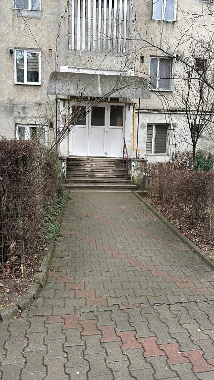 a brick walkway in front of a house at Robert's Apartment in Bistriţa