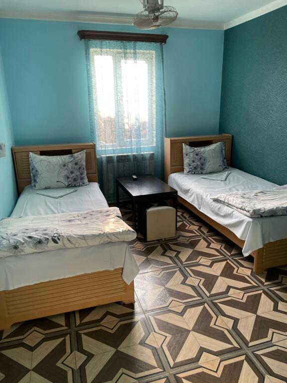 Postel nebo postele na pokoji v ubytování Zangu Hotel