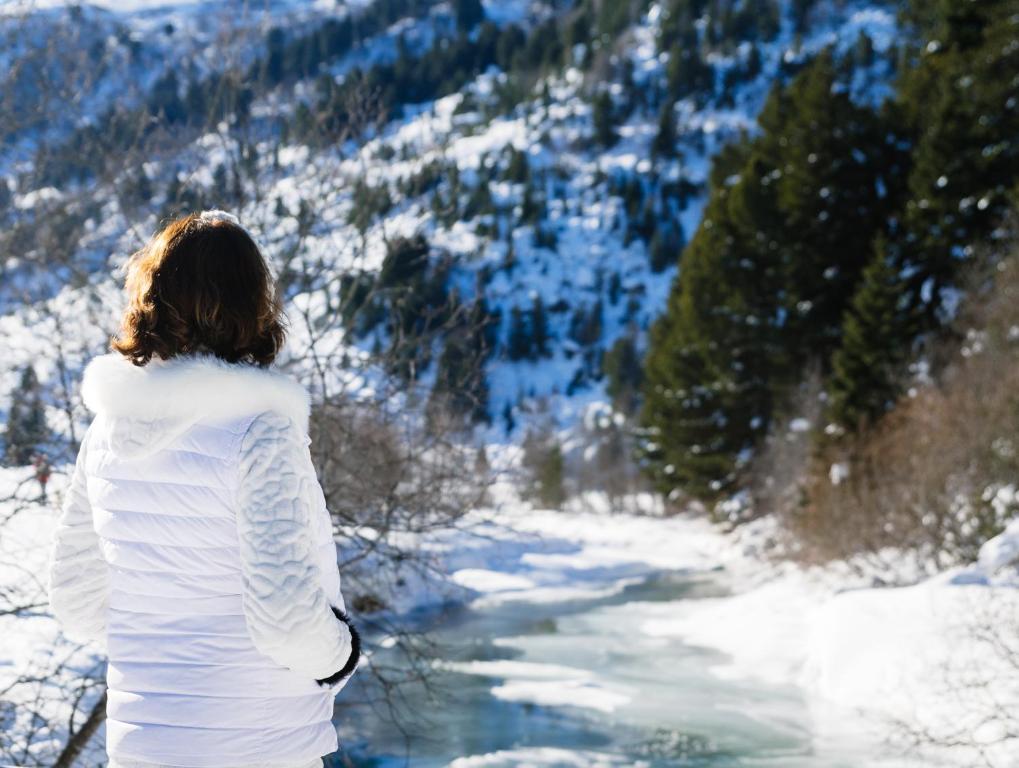 a woman standing on top of a snow covered mountain at Hôtel Alpen Ruitor in Méribel