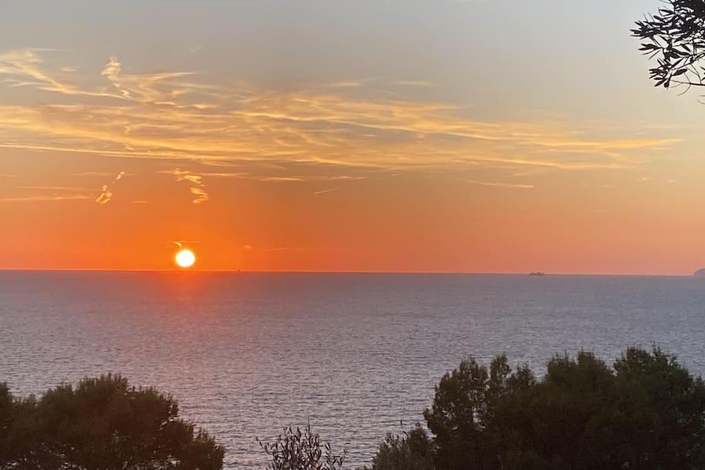 a sunset over a large body of water at La GEMMA di Orrico in Anacapri