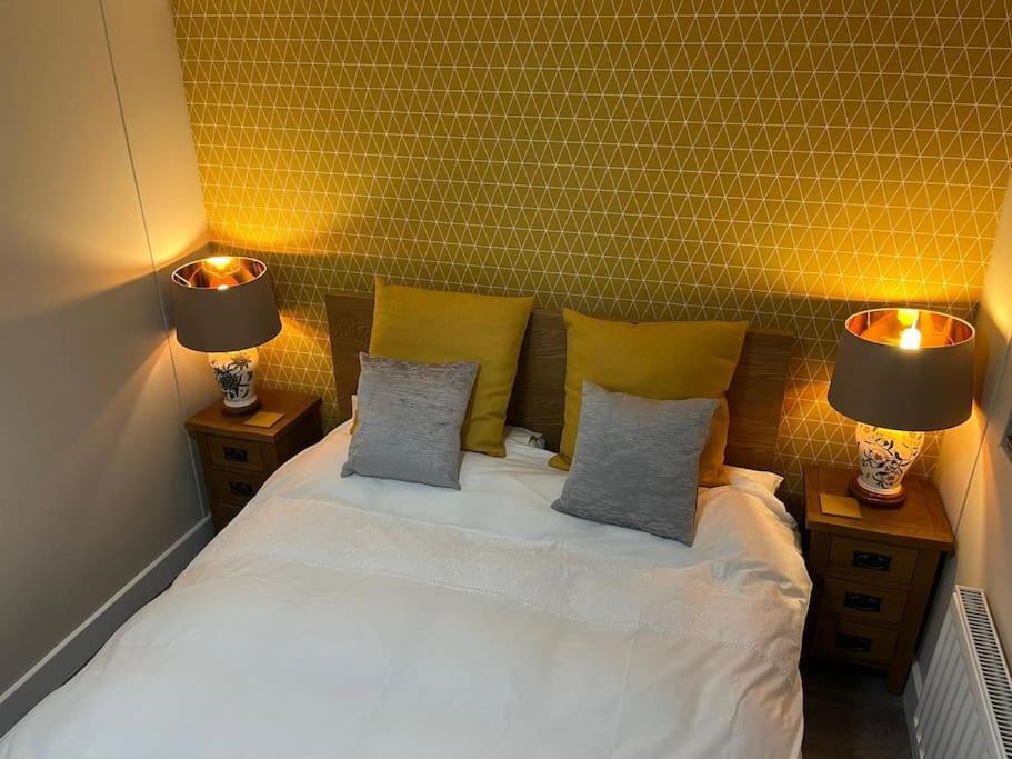 a bedroom with a white bed with two lamps on it at The Cherries - Caer beris holiday park 2 bedroom lodge - No commercial vehicles allowed on site in Builth Wells