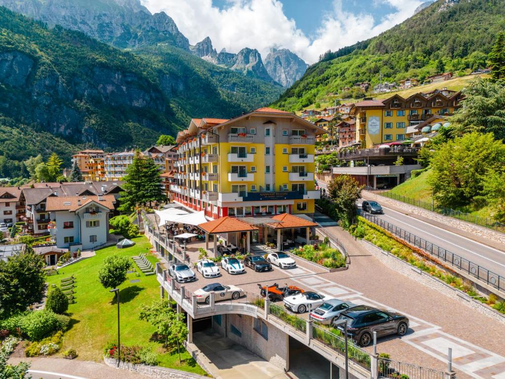 an aerial view of a town with mountains in the background at Alpenresort Belvedere in Molveno