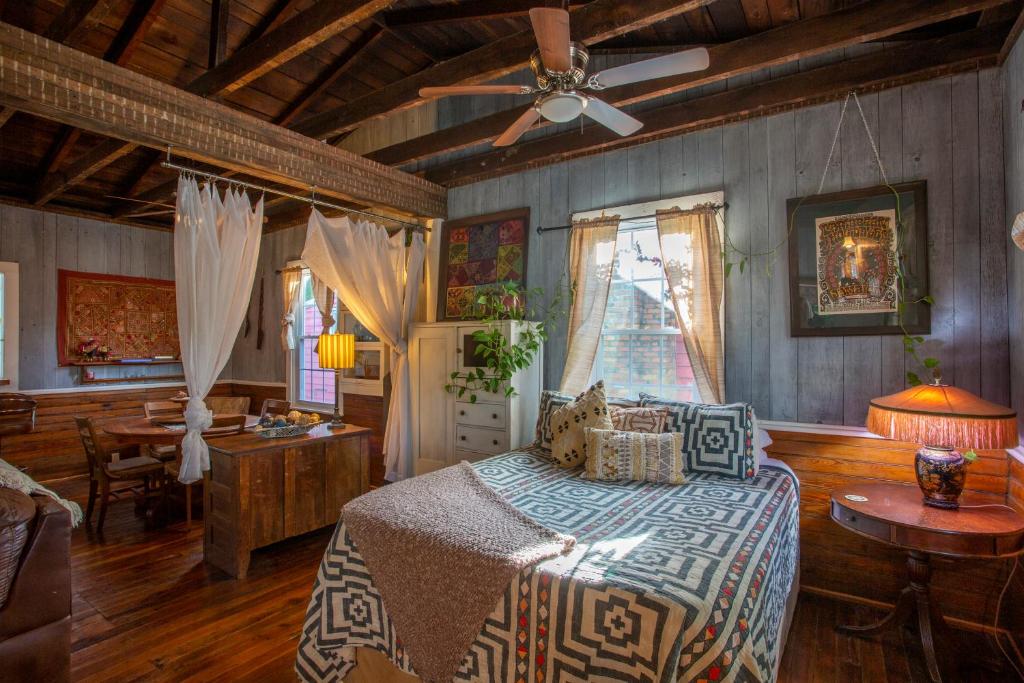 a bedroom with a bed and a ceiling fan at Stella Blue - B in Savannah