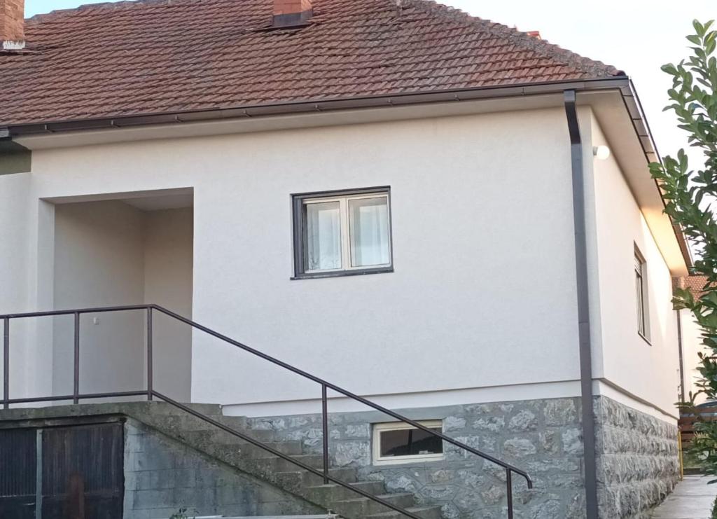 a house with a glass railing on the side of it at NAS DOM OPLENAC in Topola