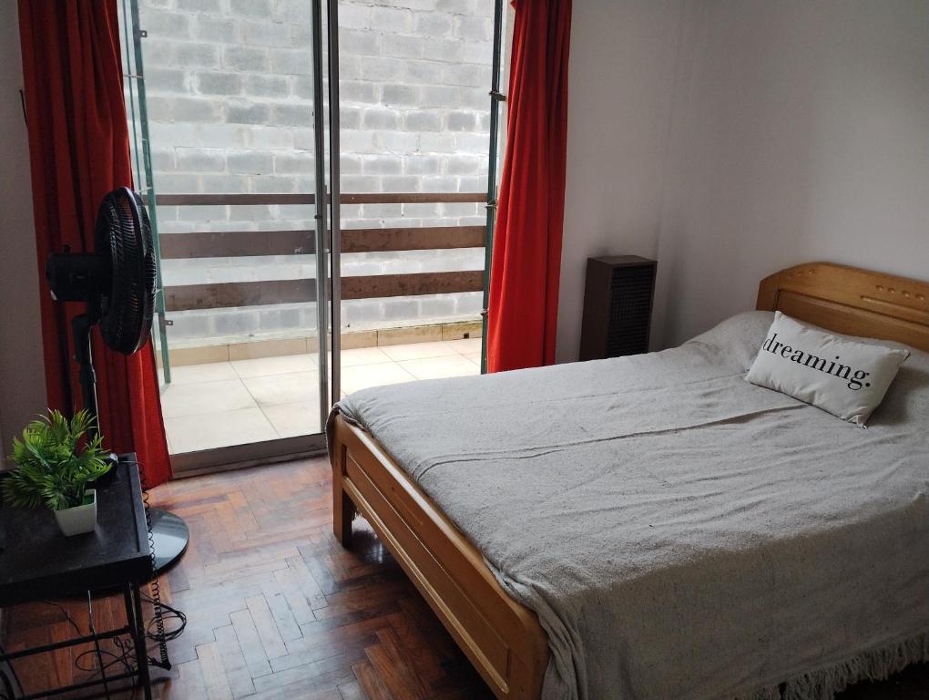 a bedroom with a bed and a large window at La Brisa in Mar del Plata