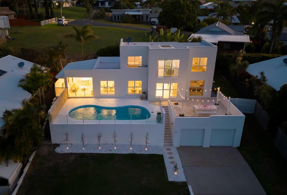 an aerial view of a house with a swimming pool at WhitsunStays - The Cyclades in Mackay