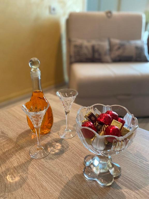 a table with a bowl of fruit and a bottle of alcohol at Apartmani Jaz 24 in Budva