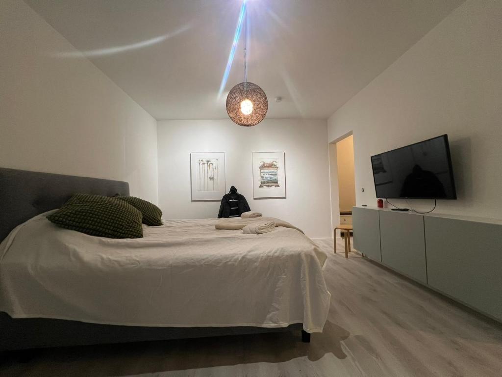 a bedroom with a bed and a flat screen tv at Roomvantaa in Vantaa
