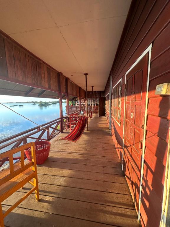 a porch of a building with a view of the water at Happy bangalow riverside in Muang Không