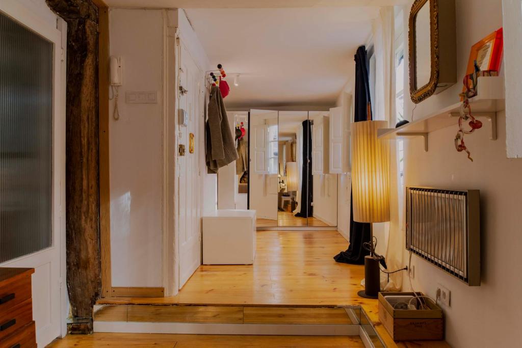 a hallway of a home with wooden floors and white walls at Acogedor apartamento en Bilbao in Bilbao