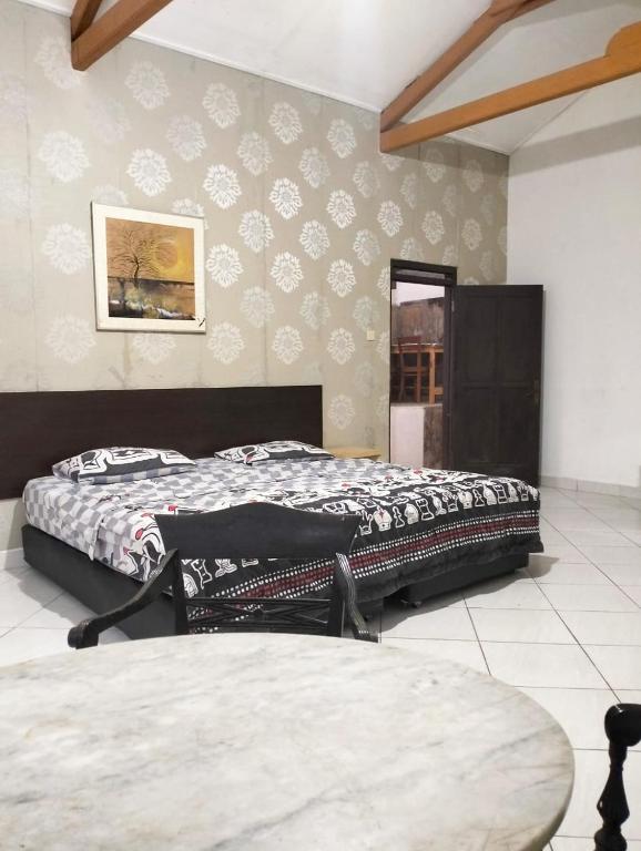 1 dormitorio con 2 camas y un cuadro en la pared en Villa sagitarius en Bogor