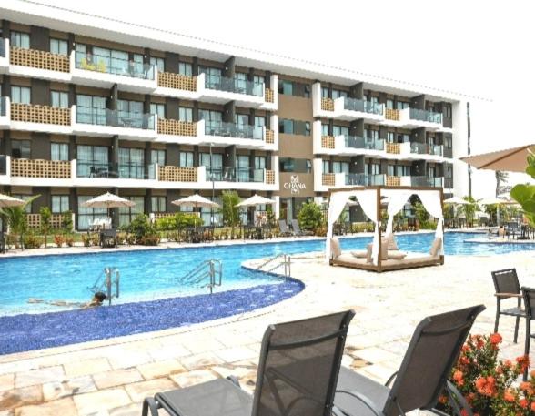 a large apartment building with a large swimming pool at Mana Beach Experience - Porto de Galinhas - Muro Alto Alto in Ipojuca