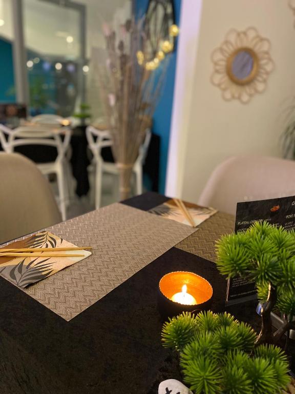 a table with a candle on top of a table at Hotel La Voile in Bormes-les-Mimosas