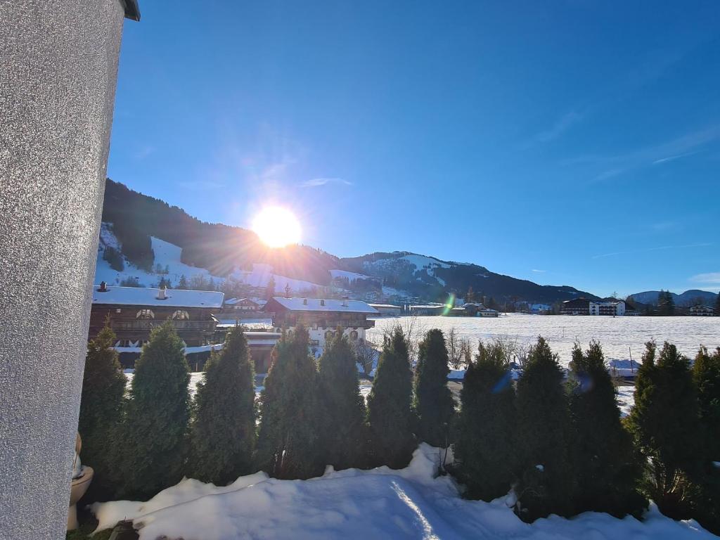 a view of the sun setting over a snow covered mountain at Going EASY in Going