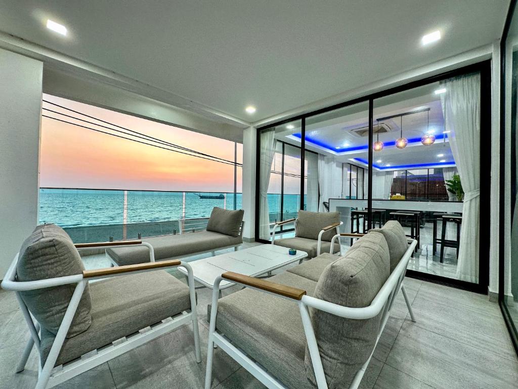 a living room with a view of the ocean at STUNNING BEACHFRONT VIEW LUXURIOUS Apartment 30 in Jomtien Beach