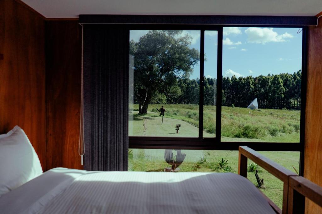 Postel nebo postele na pokoji v ubytování MUMA Hotel - Museo de la Madera