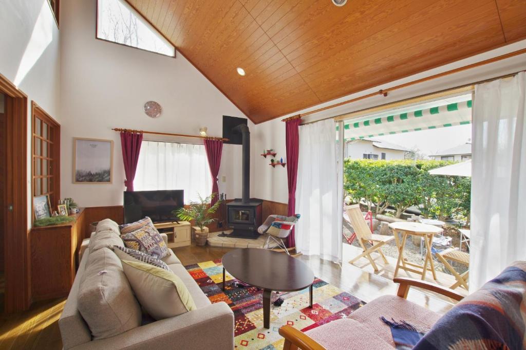 a living room with a couch and a table at VILLENTFujimiHiekawa - Vacation STAY 93591v in Izu